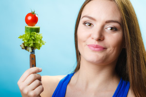 Attractive woman holding healthy food.